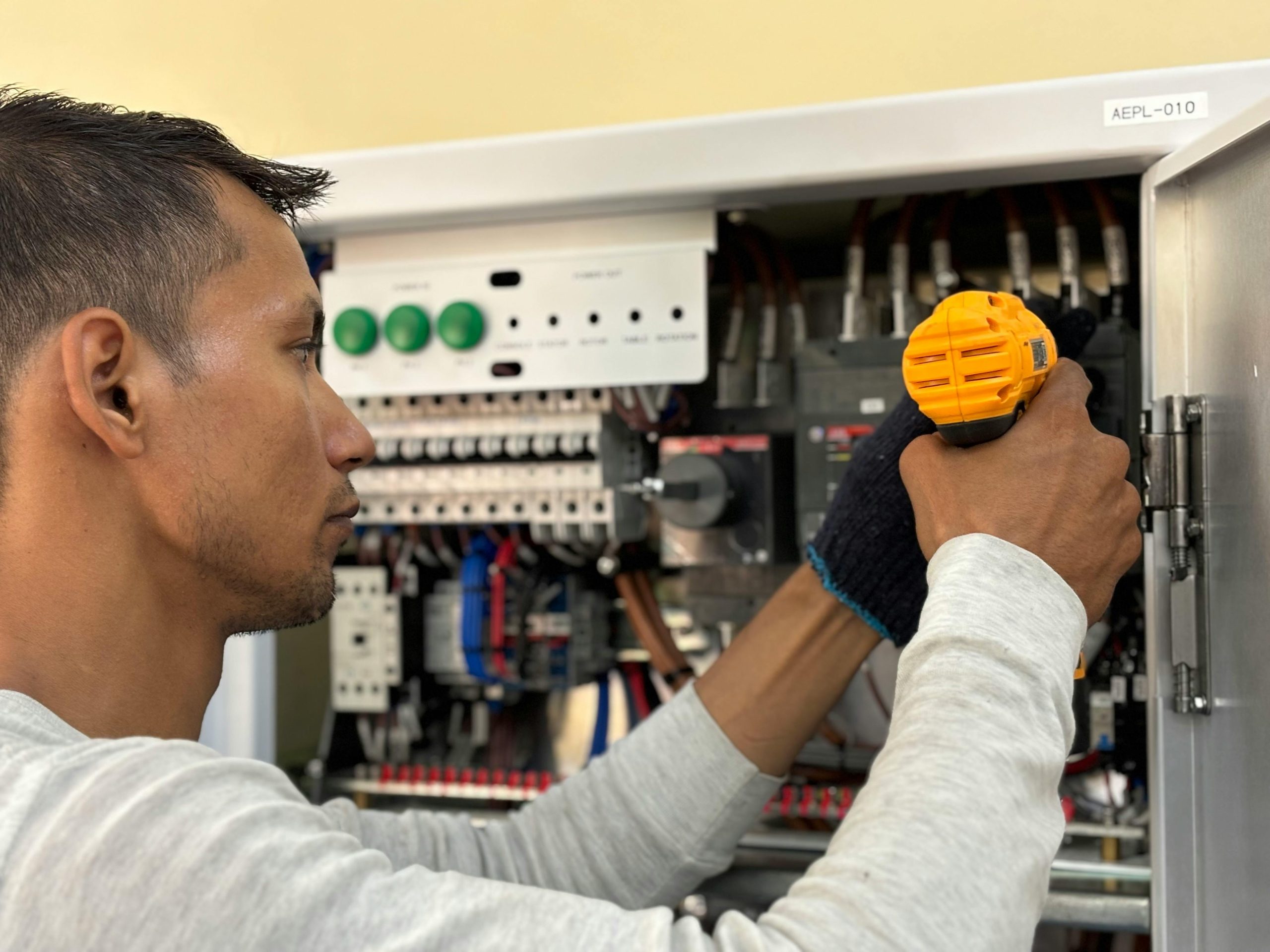 Licensed electrician installing electrical components in a home