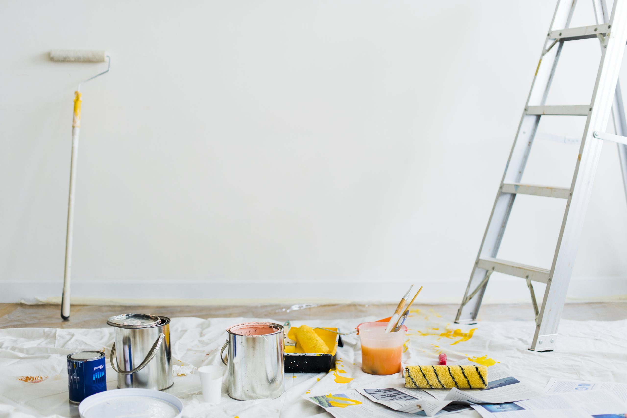 Buckets of paint on the floor Freshly painted living room with smooth interior wall finishes